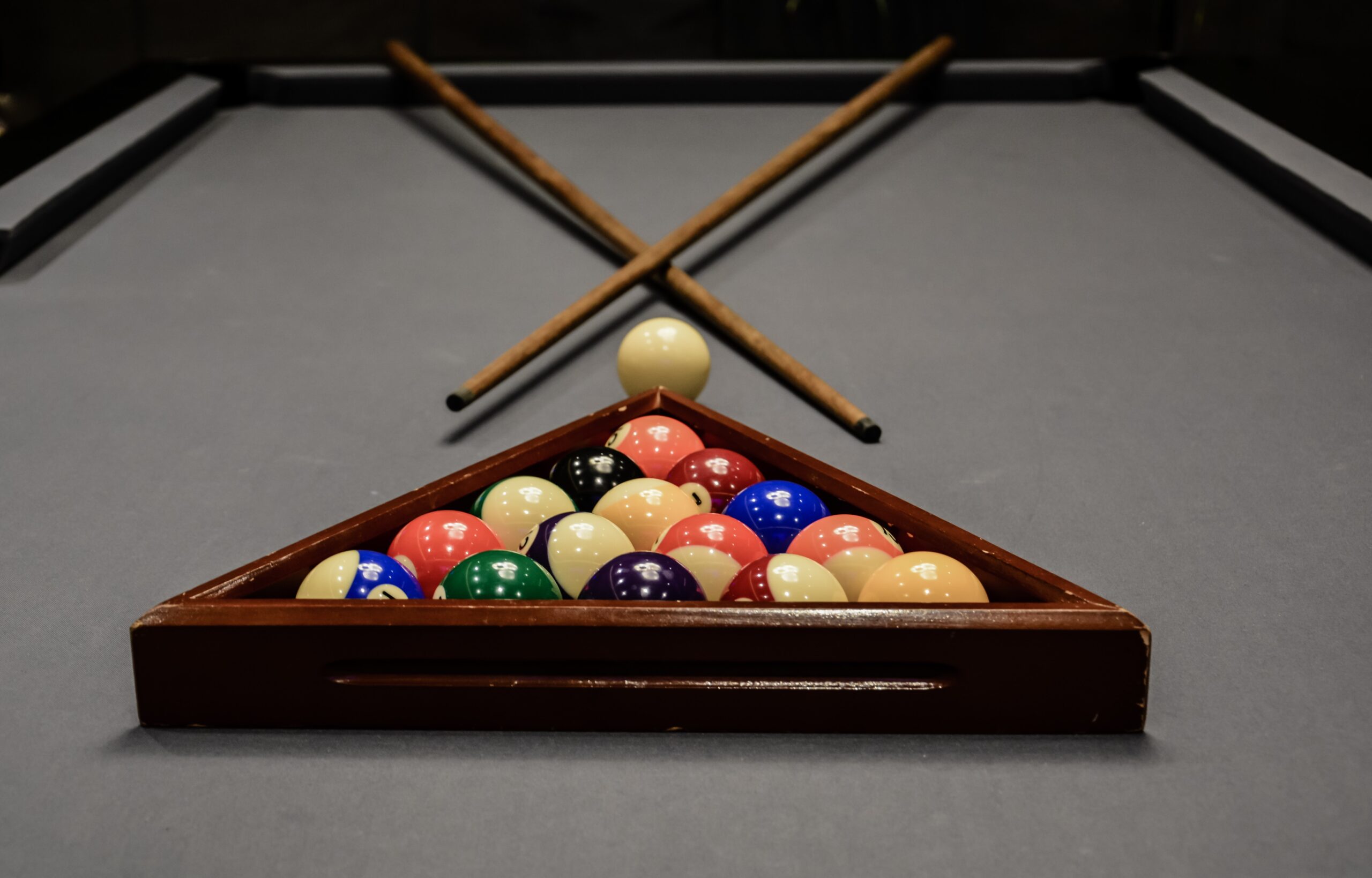 pool tables with universal tr triangle rack and cue player on grey cloth