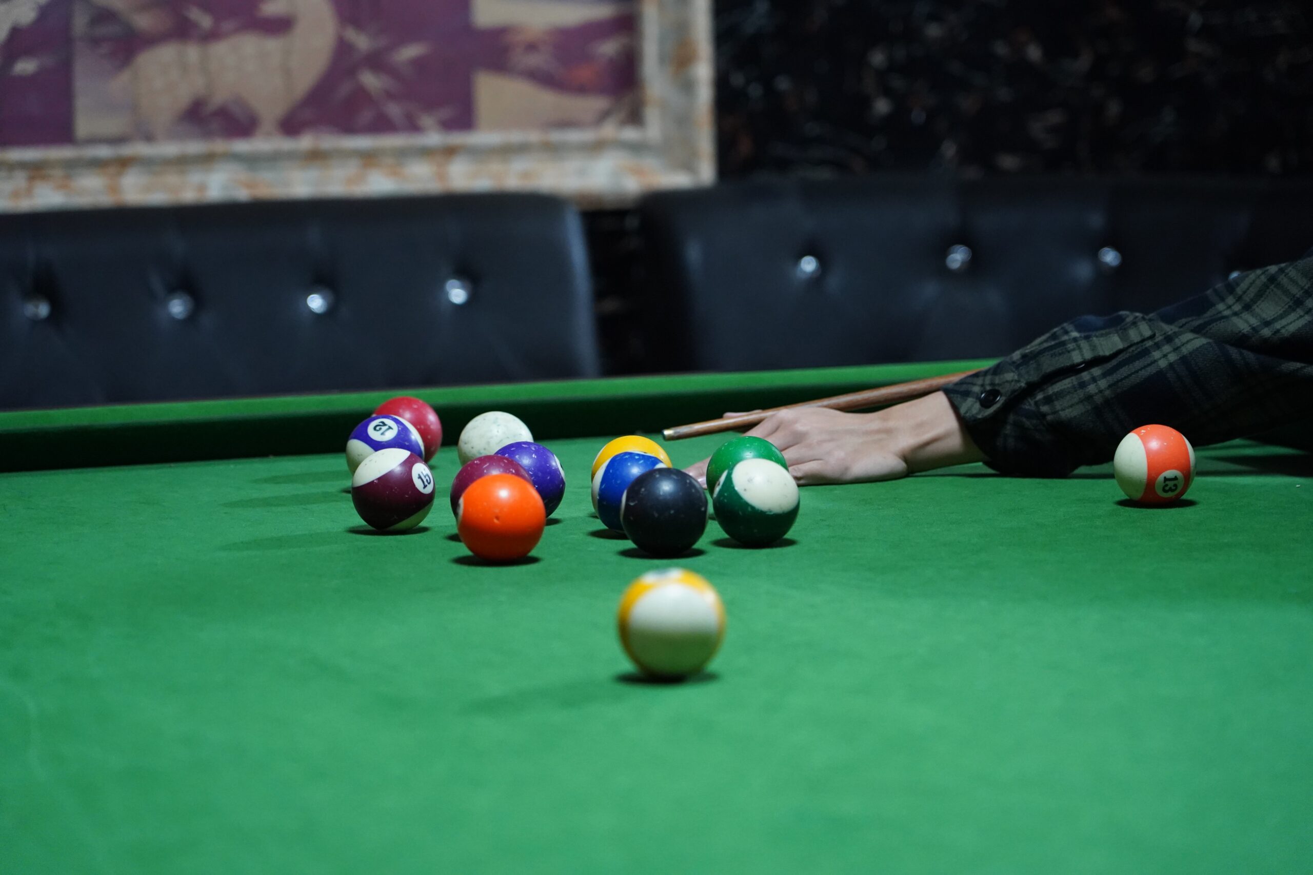 pool tables with universal tr triangle rack and cue player on green cloth