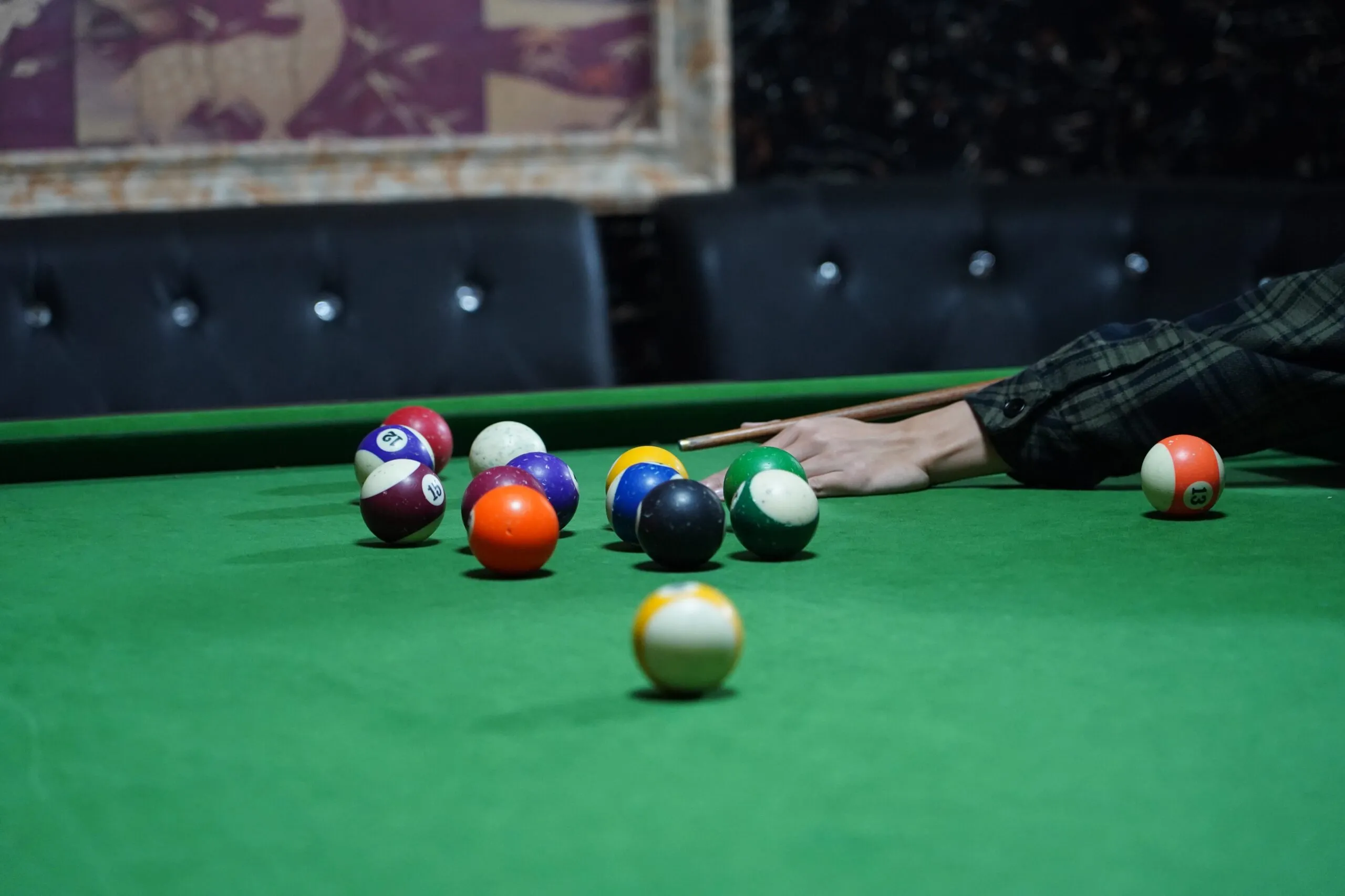 pool tables with universal tr triangle rack and cue player on green cloth